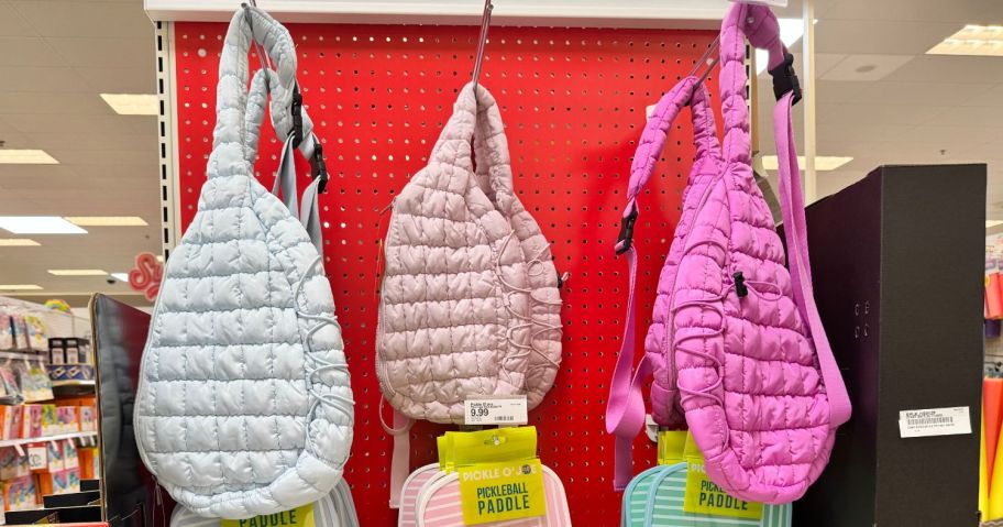 three Pickle O'Joe Quilted Sling Pickleball Bags hanging in store