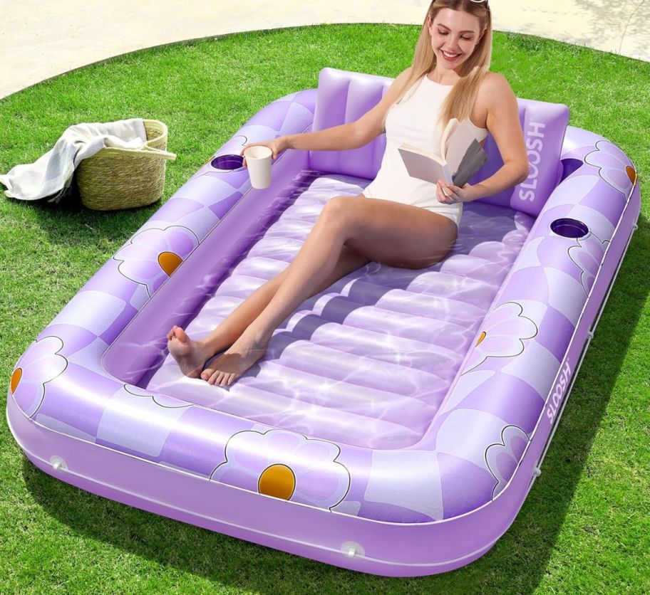 a woman lounging in an inflatable tanning pool