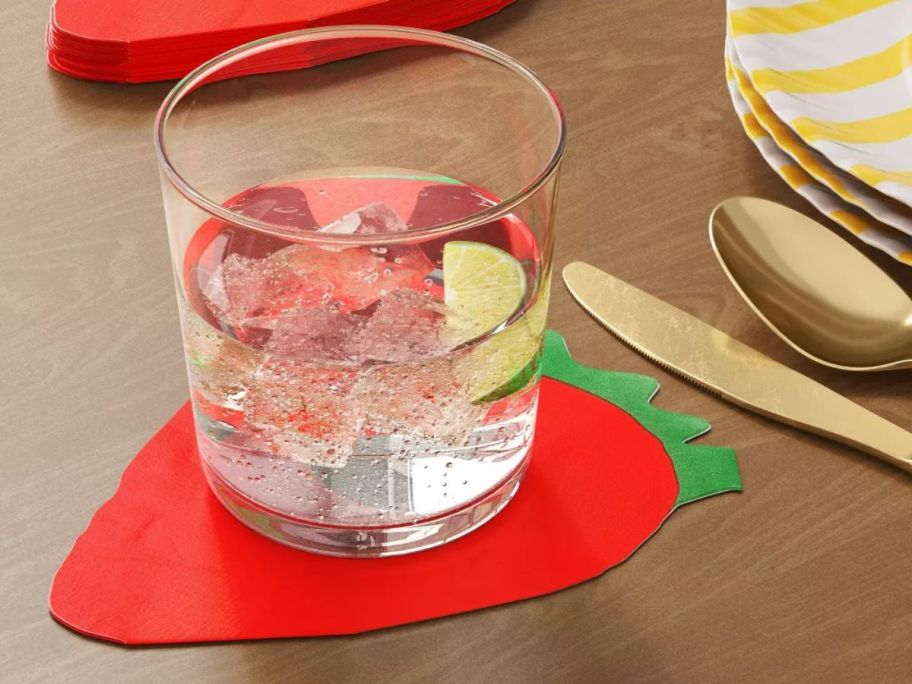 Room Essentials Strawberry Figural Napkin underneath a drink on table