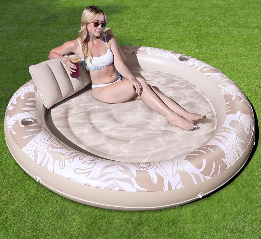 a woman lounging in an inflatable tanning pool