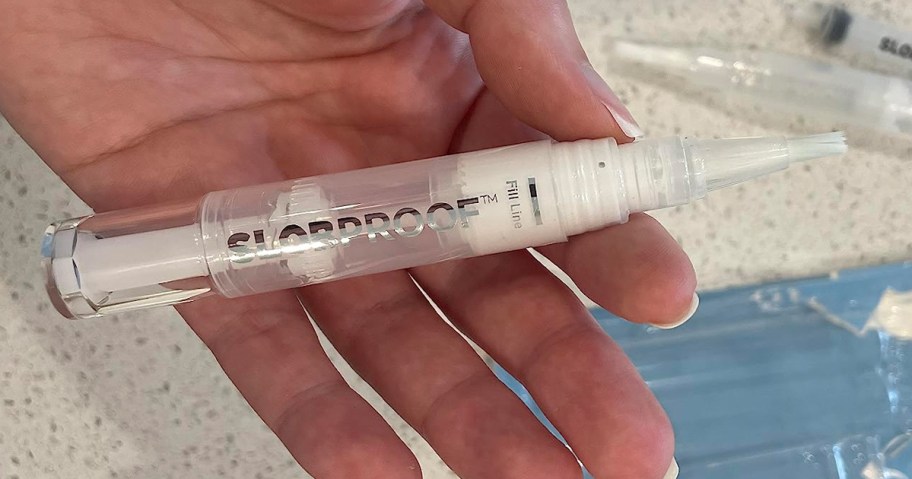 person holding paint pen
