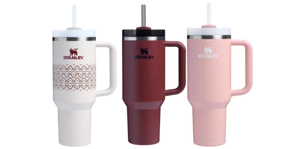 various colored stanley tumblers on white background