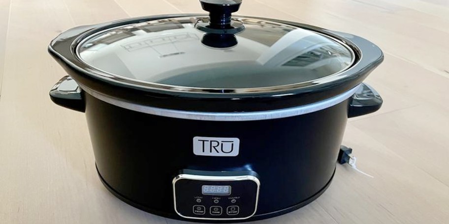 black slow cooker with lid on table