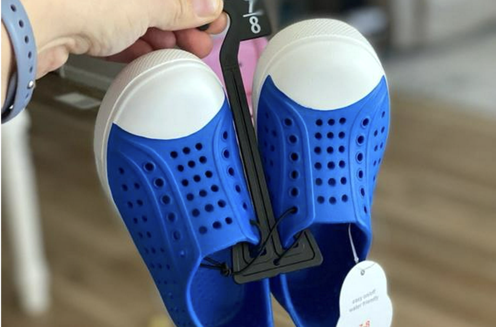 holding Walmart water shoes 