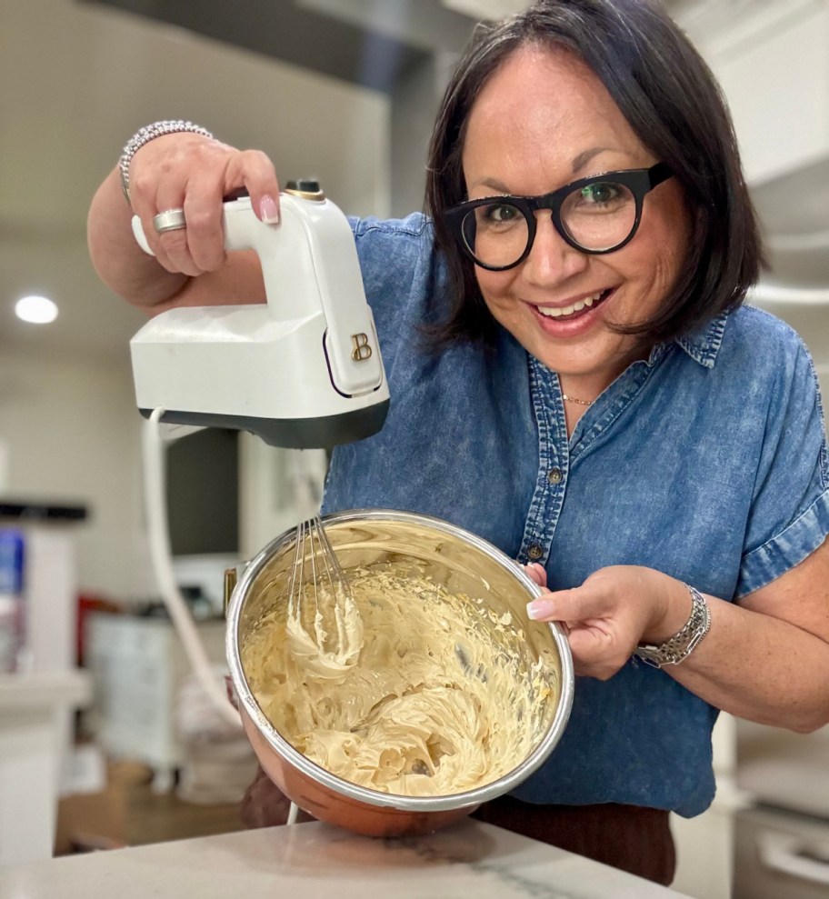 woman making whipped honey butter with a hand mixer